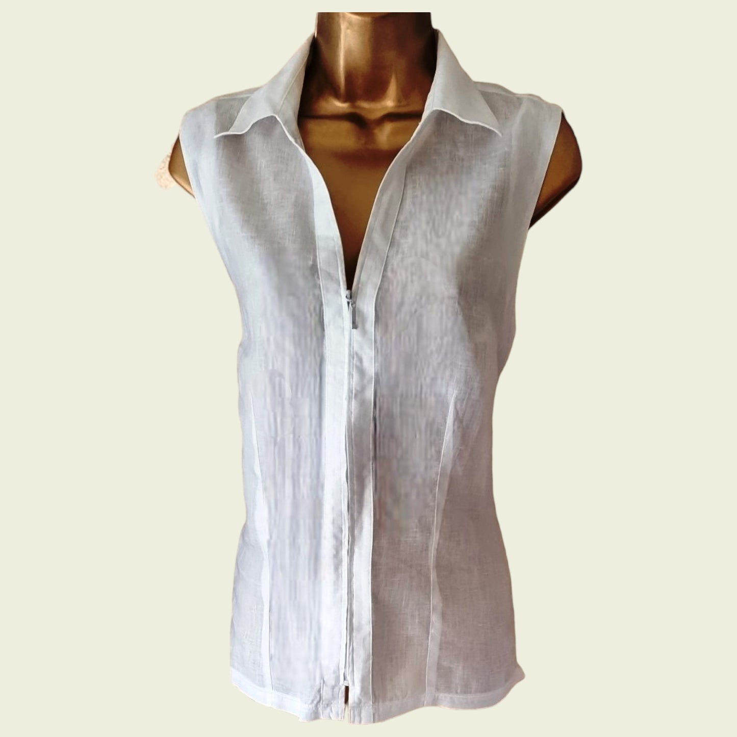 White sleeveless shirt on a mannequin against a beige background
