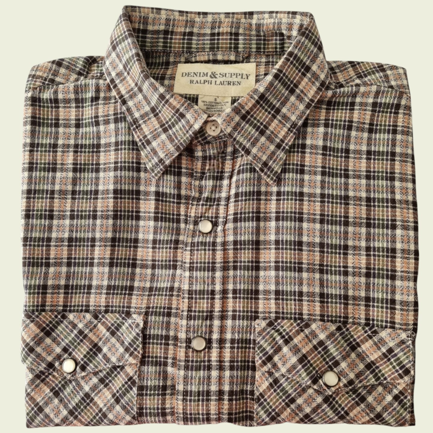 Brown check shirt on a beige background
