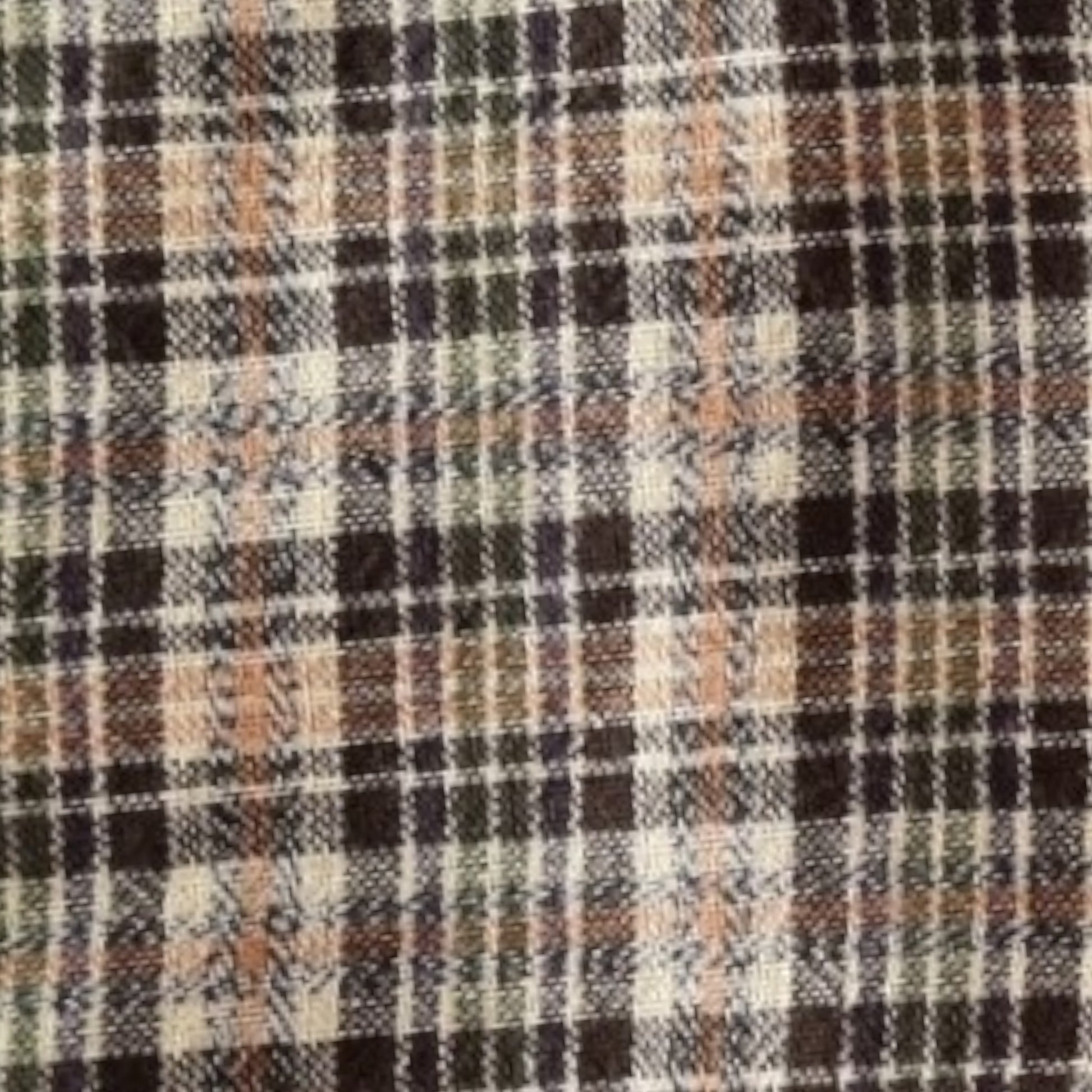 Close-up of a plaid fabric with brown, black, and beige colors.
