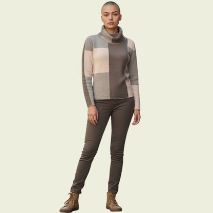 Person wearing a checkered sweater and dark pants on a beige background