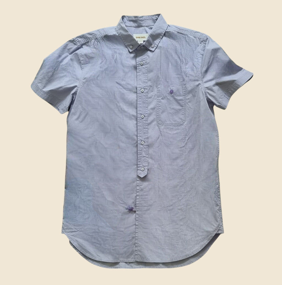 Lilac short-sleeve button-up shirt on a beige background