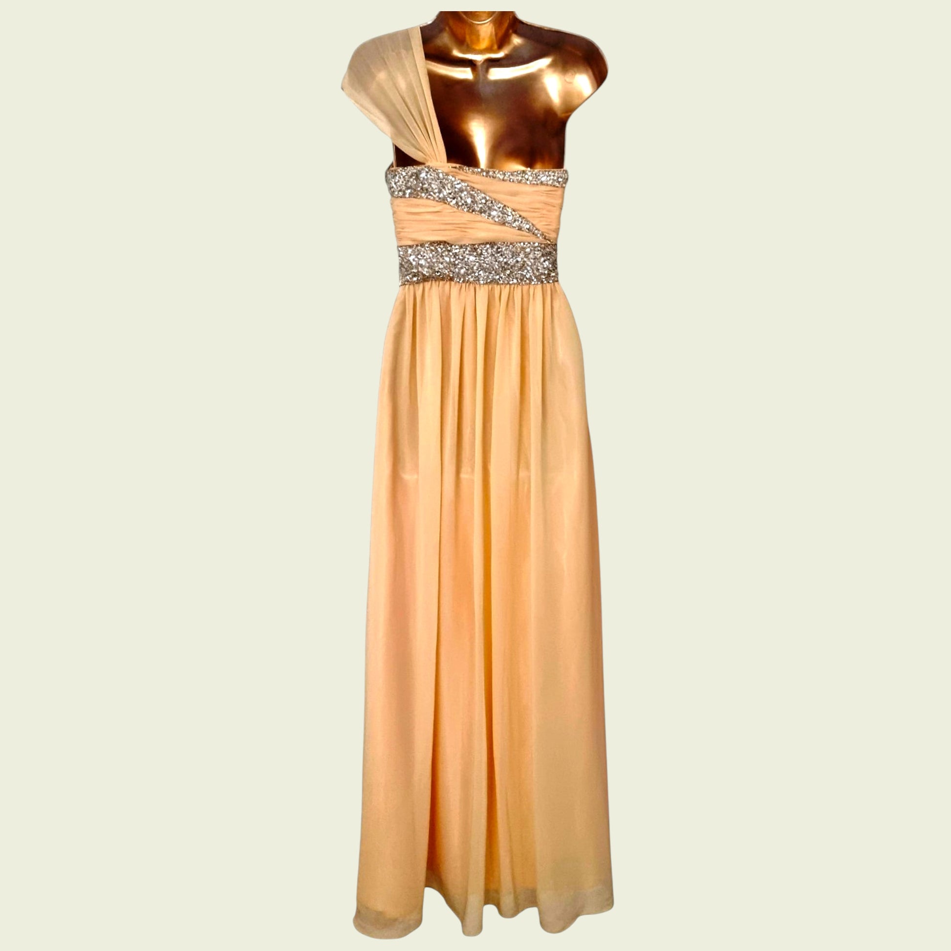 Orange evening gown with a beaded waistband on a mannequin against a beige background