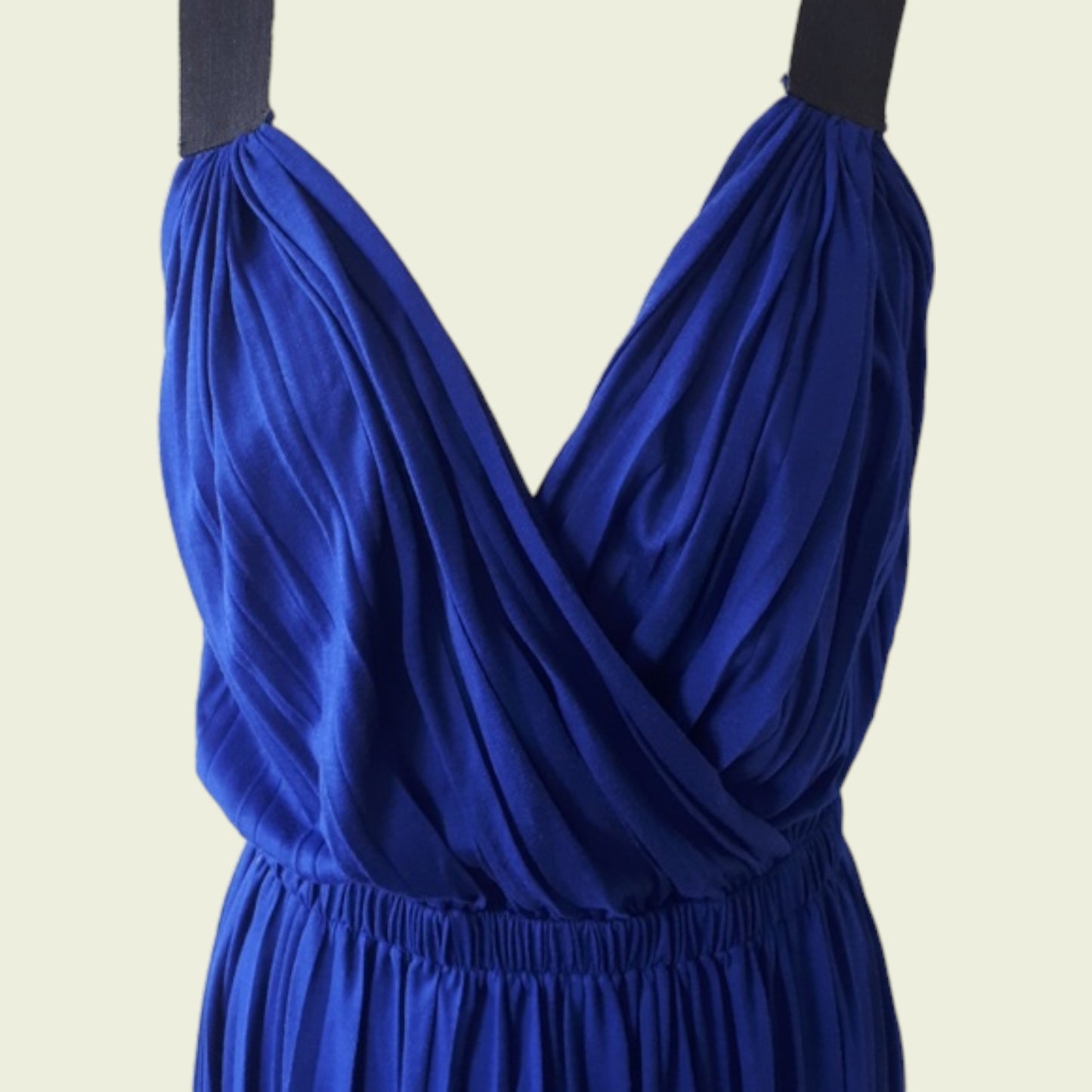 Blue dress with a plunging neckline on a beige background
