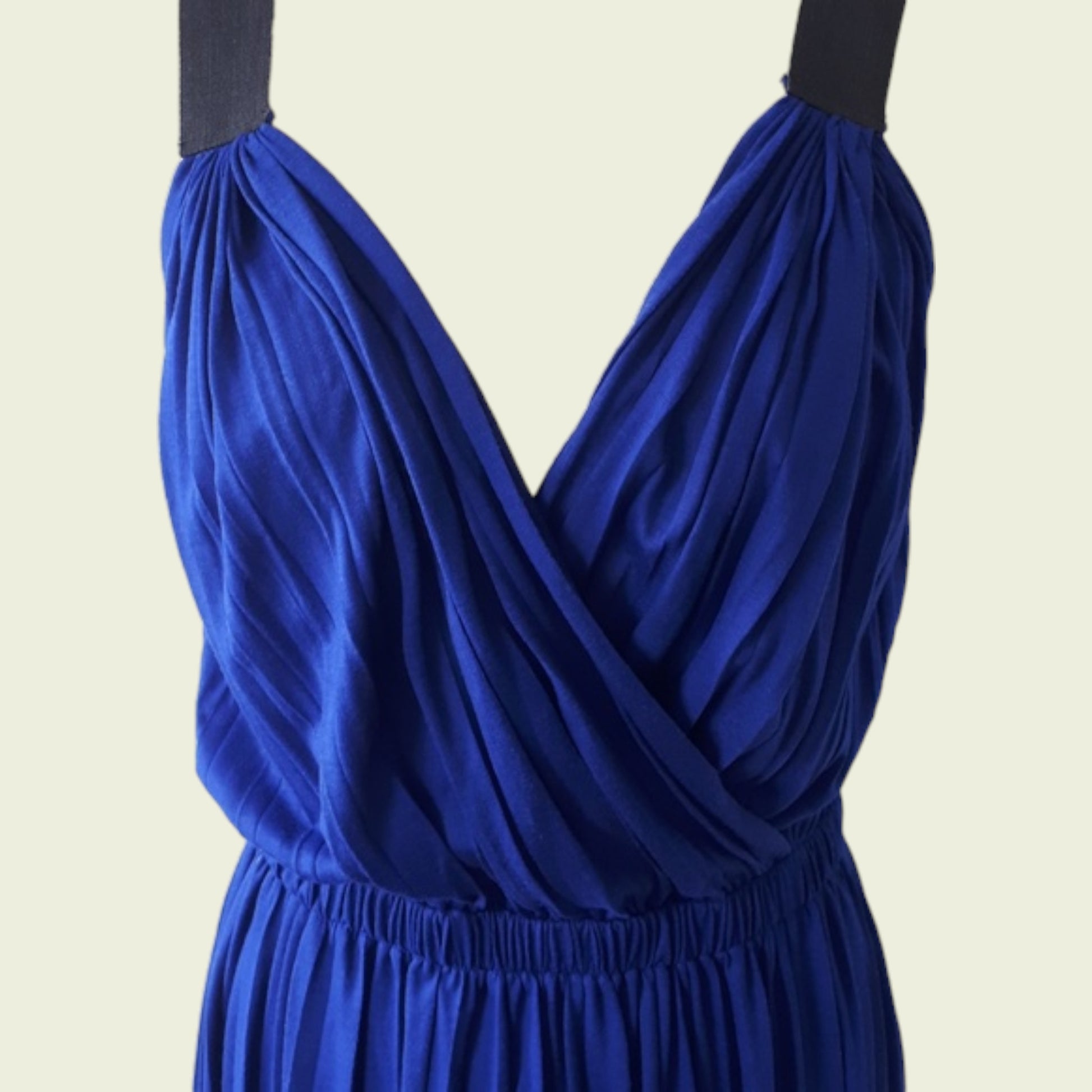 Blue dress with a plunging neckline on a beige background
