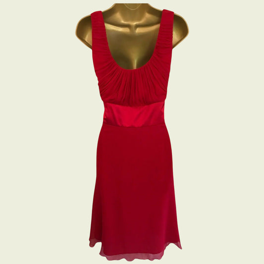 Red dress on a mannequin against a beige background