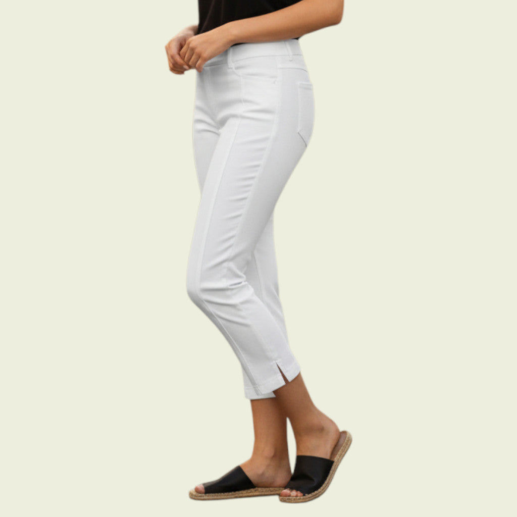 White pants worn by a person on a beige background