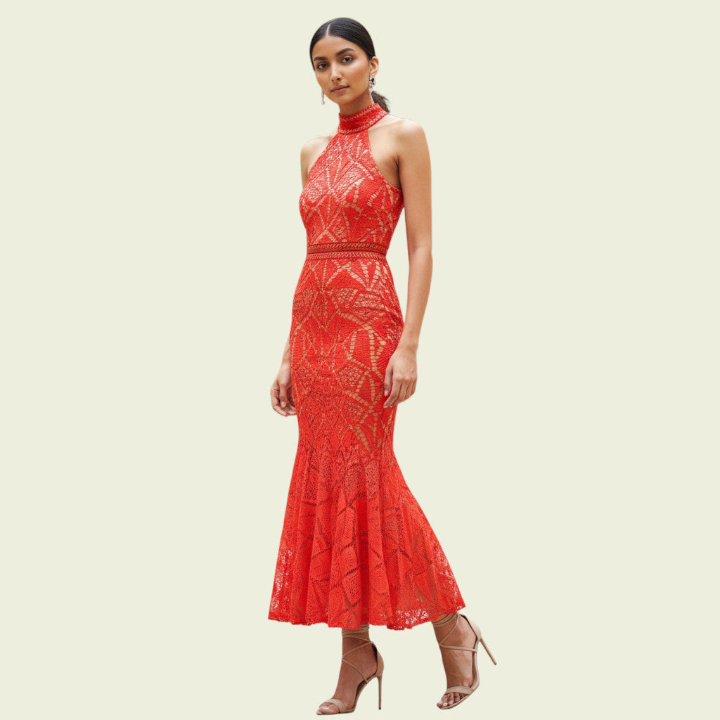 Woman wearing a red lace dress on a beige background