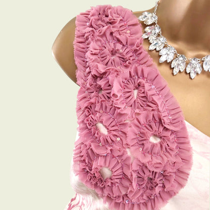 Close up of mannequin with pink and cream floral corsage on beige background