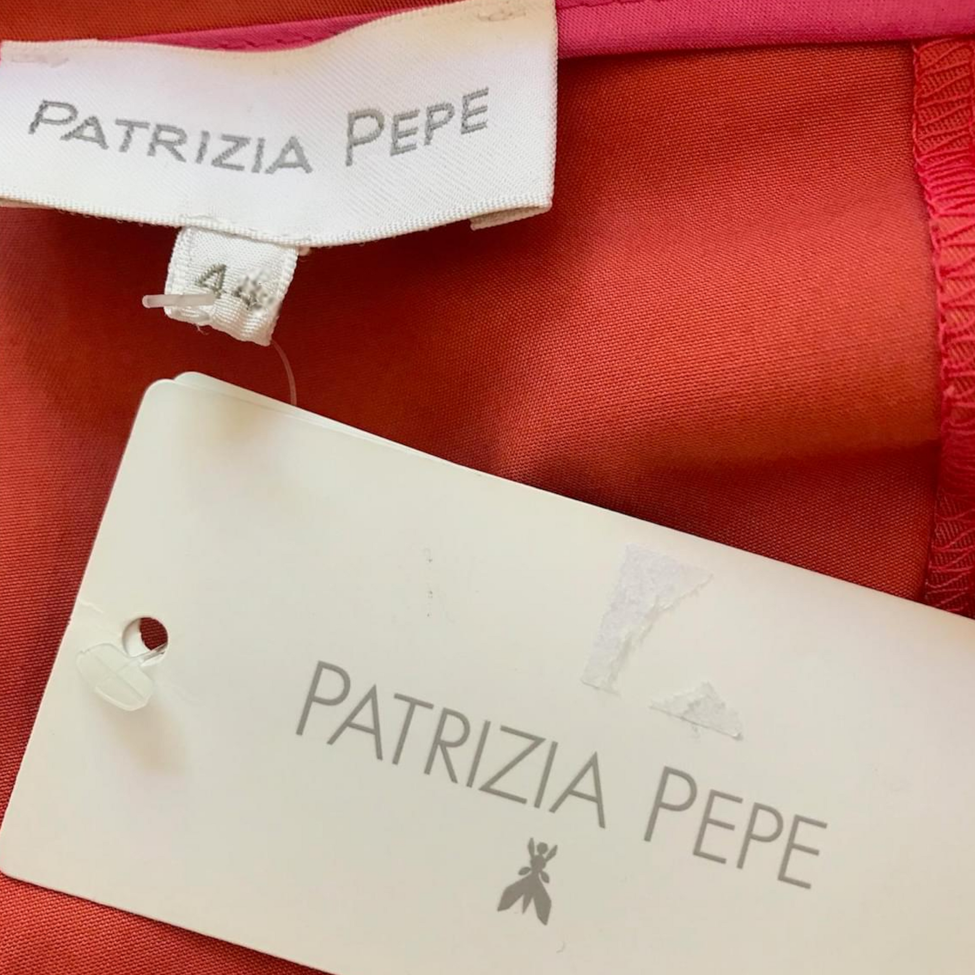 Patrizia Pepe label on a red fabric background