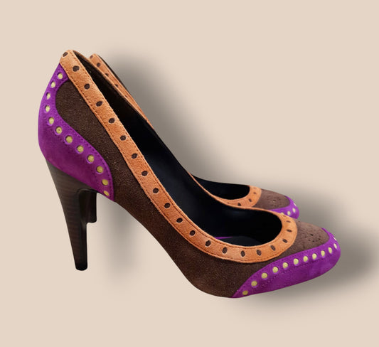 High-heeled shoes with brown and purple design on a beige background 