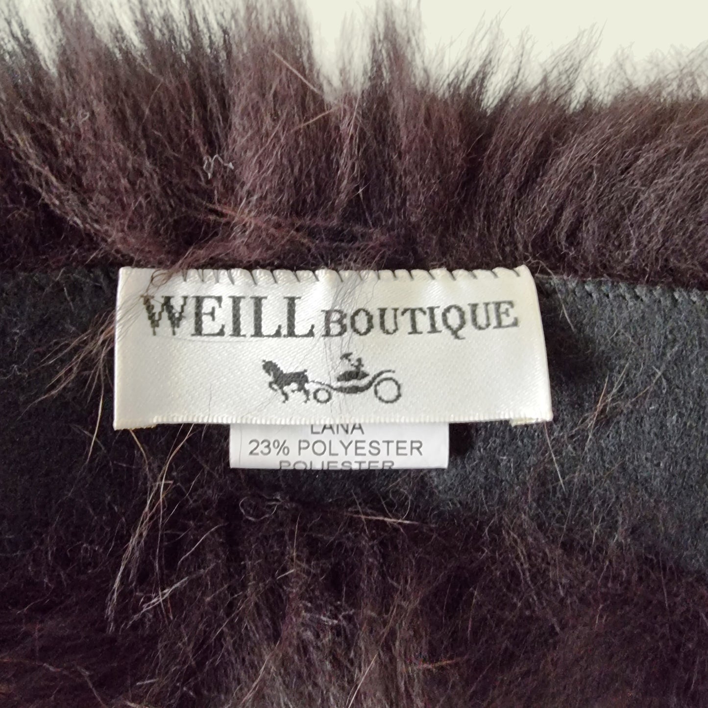 Label with Weill Boutique on brown background