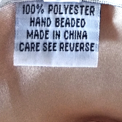 Label on fabric indicating '100% Polyester, Hand Beaded, Made in China, Care See Reverse'.