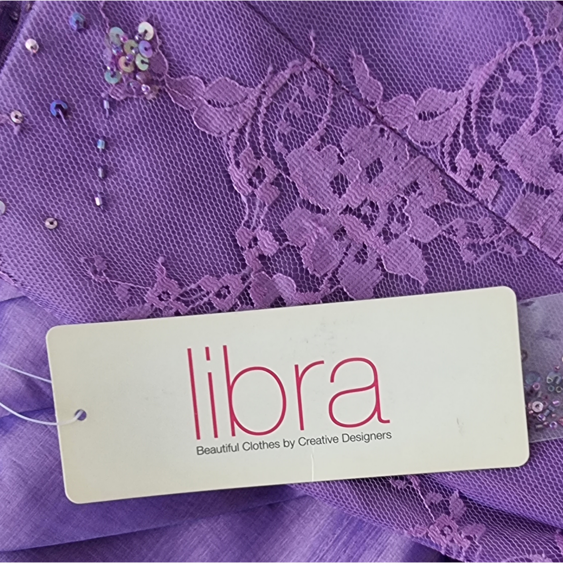 Purple lace fabric with a 'libra' brand tag