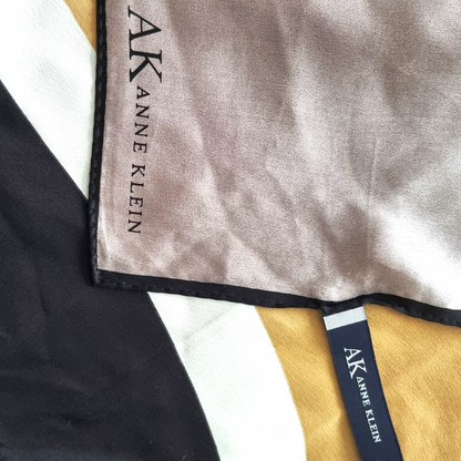 Close-up of Anne Klein fabric with brand label on a geometric background