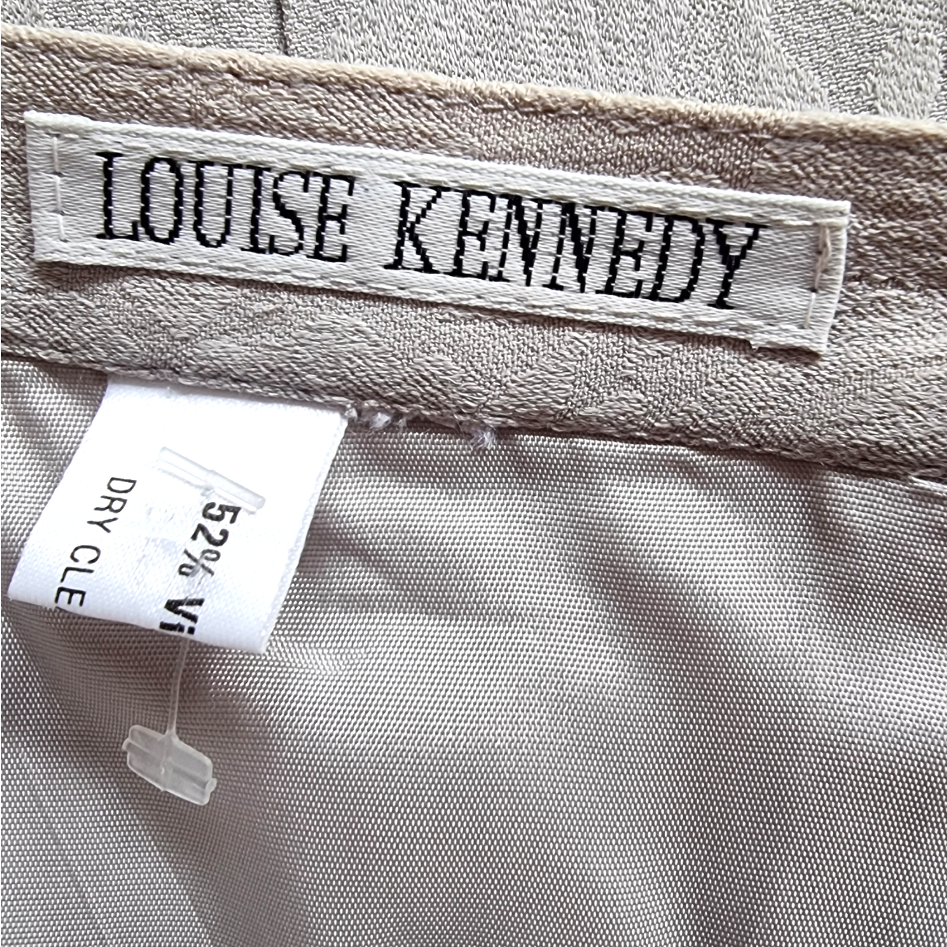 Label with 'Louise Kennedy' on a fabric background