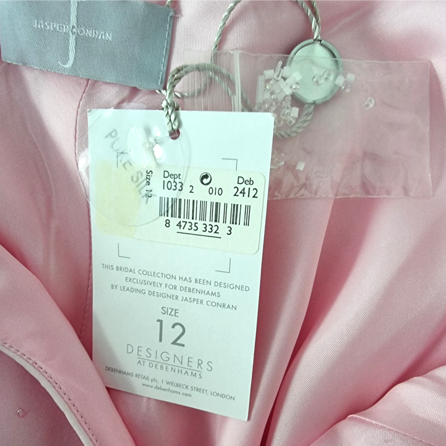 Pink garment with a tag displaying size 12 and brand information.