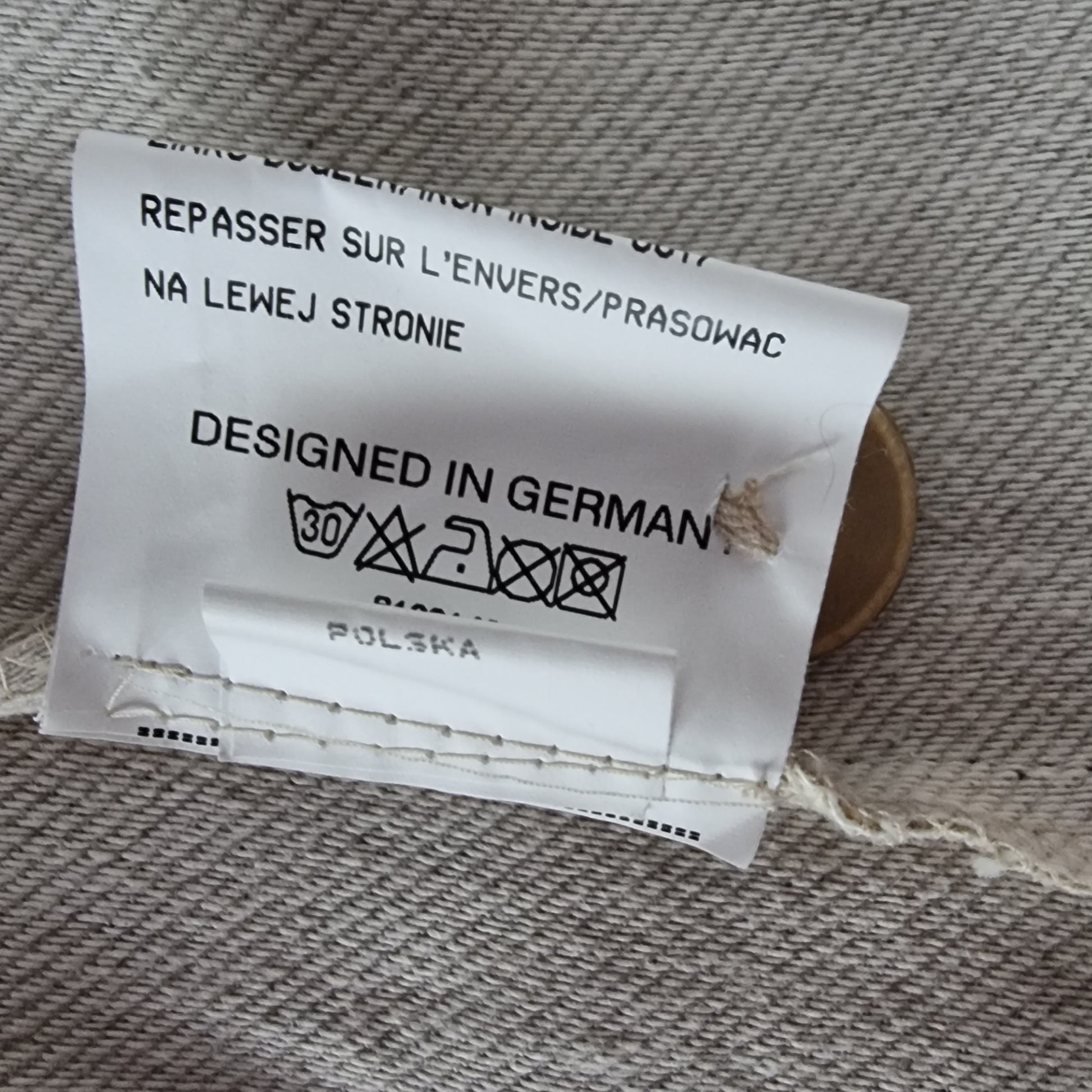 Clothing label with text on a fabric background