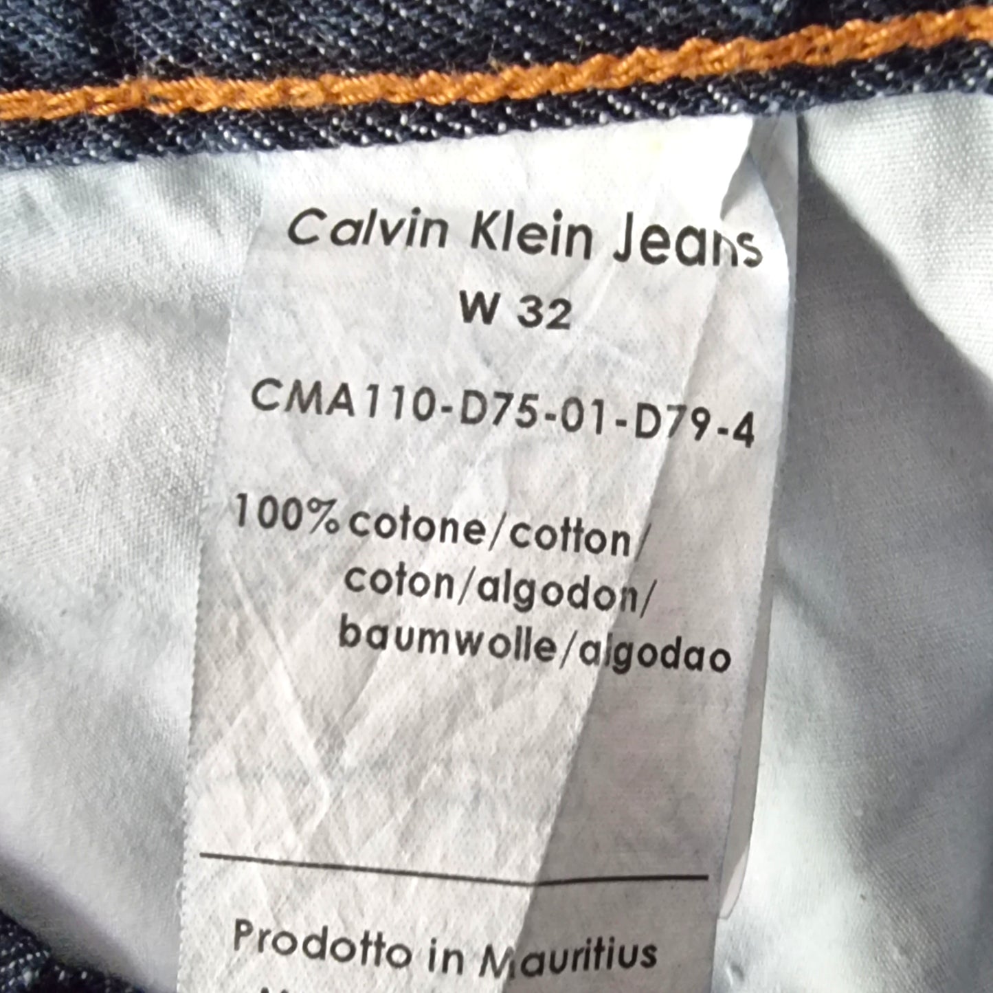 Calvin Klein Jeans label on a garment with size W32 and material information.