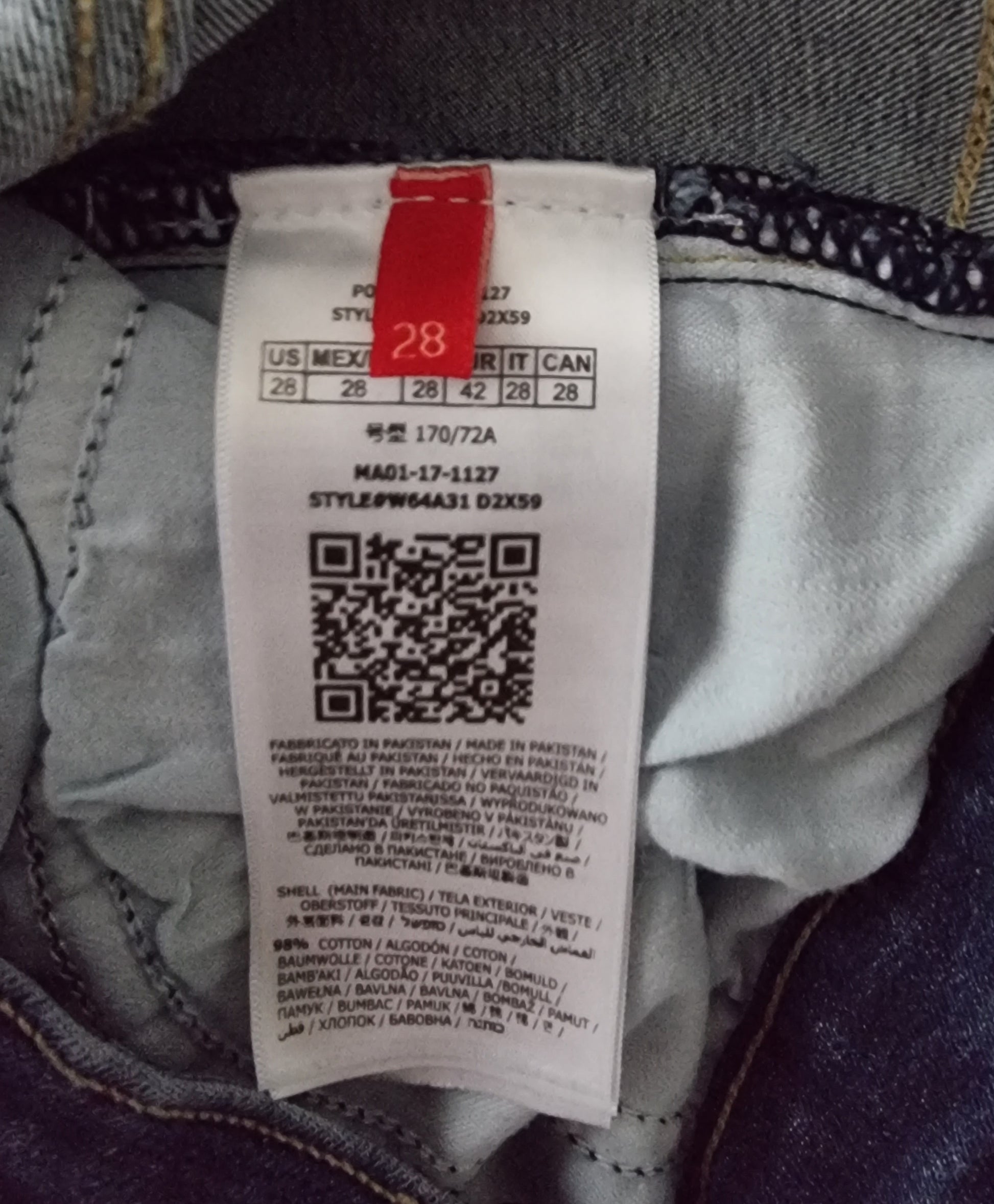 Clothing tag with size label and QR code on a garment