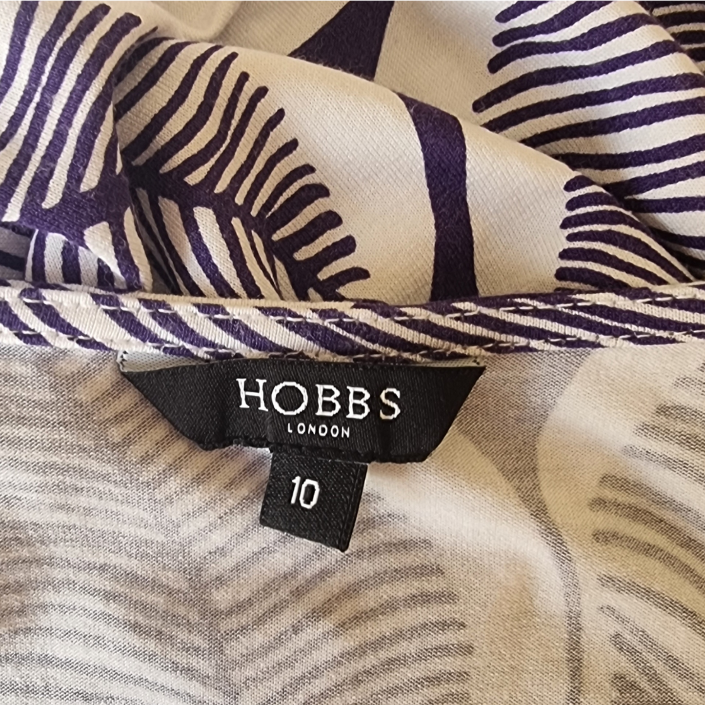 Clothing label showing Hobbs and size on blue and white background