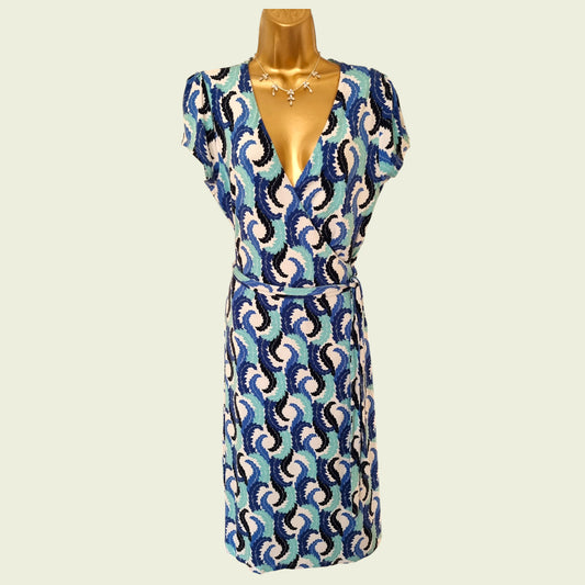 Patterned dress on a mannequin against a plain background