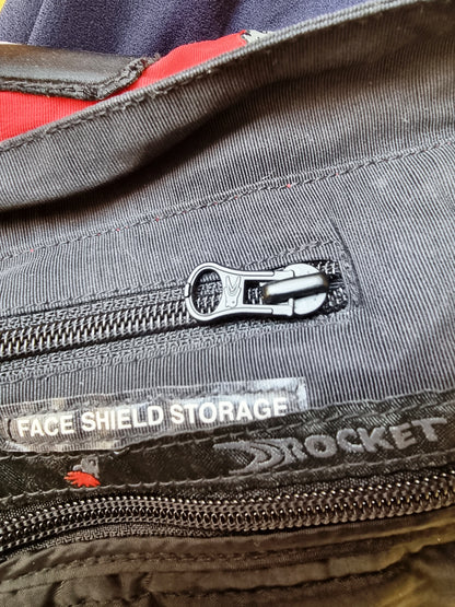 Close-up of a zipper on a jacket with 'Rocket' branding and text.