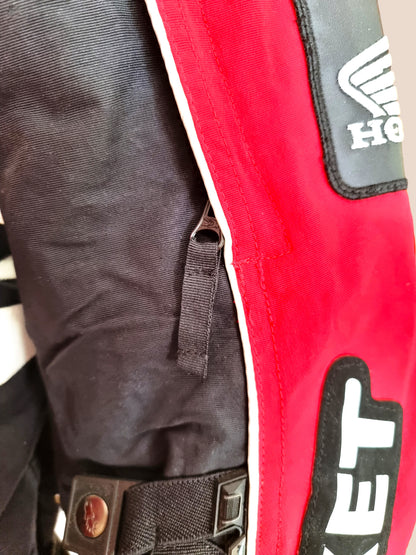 Close-up of a red and black motor cycle jacket with visible branding