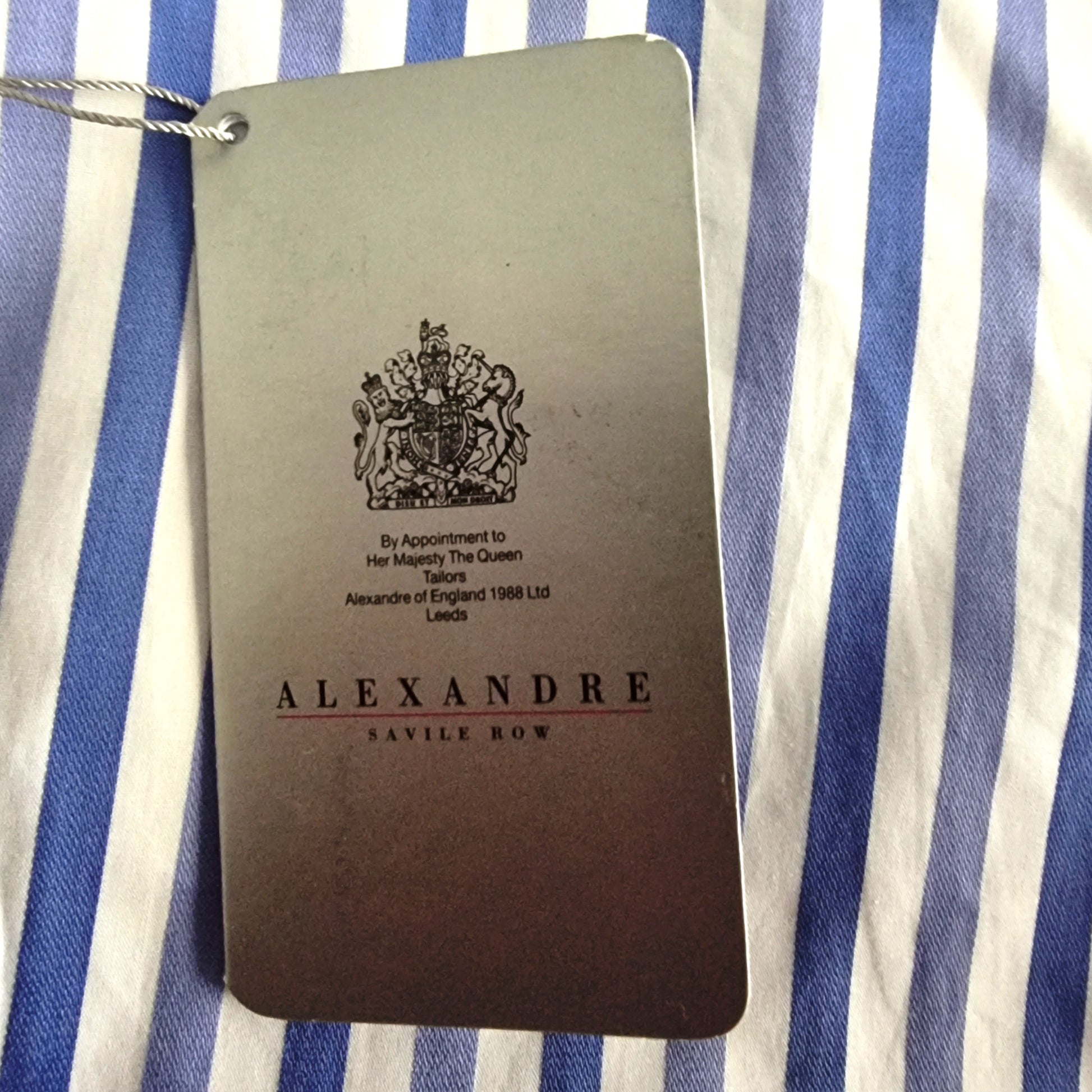 Alexandre Savile Row label on a blue and white striped fabric background