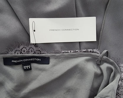 Gray garment with 'French Connection' label on a textured gray background