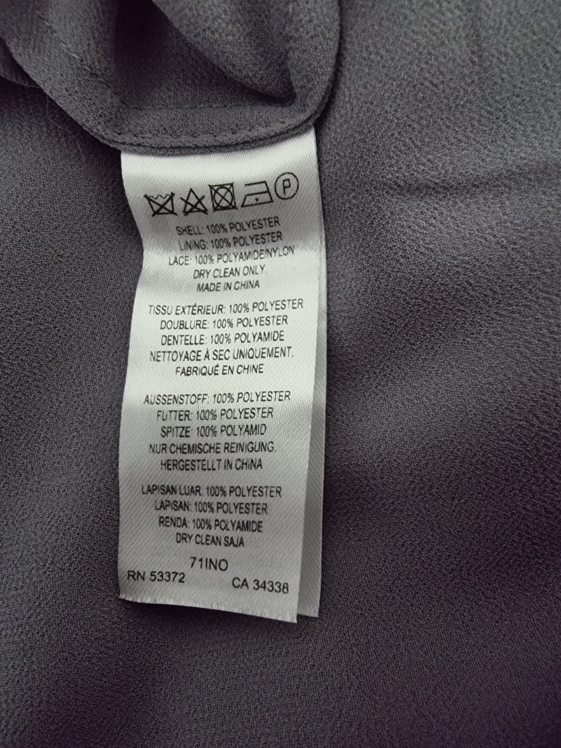 Clothing label with text on a gray fabric background