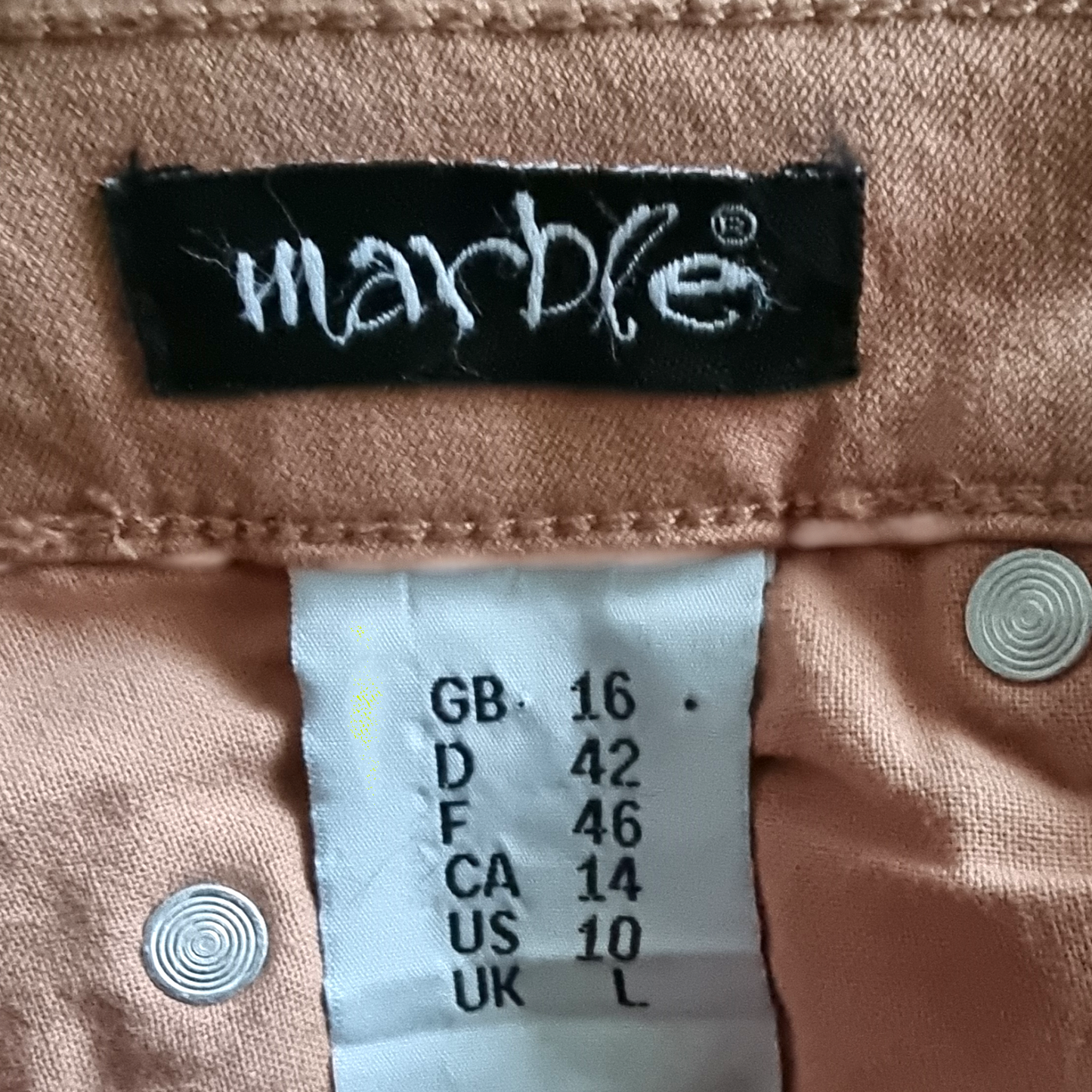 Marble brand label on a garment with size chart