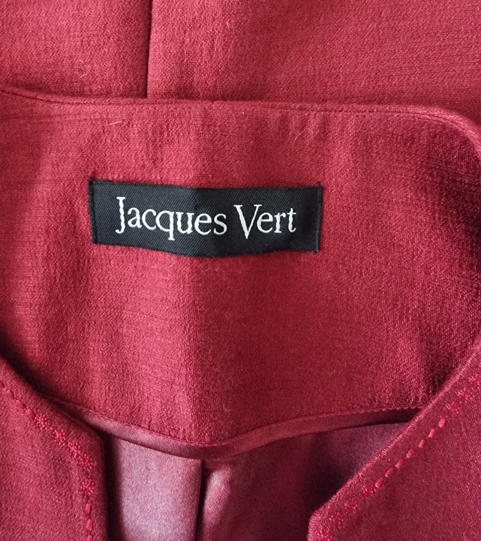 Jacques Vert label on a red fabric background