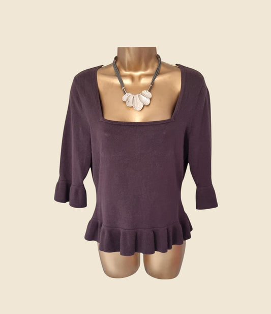 Taupe long-sleeve top on a mannequin with a beige background