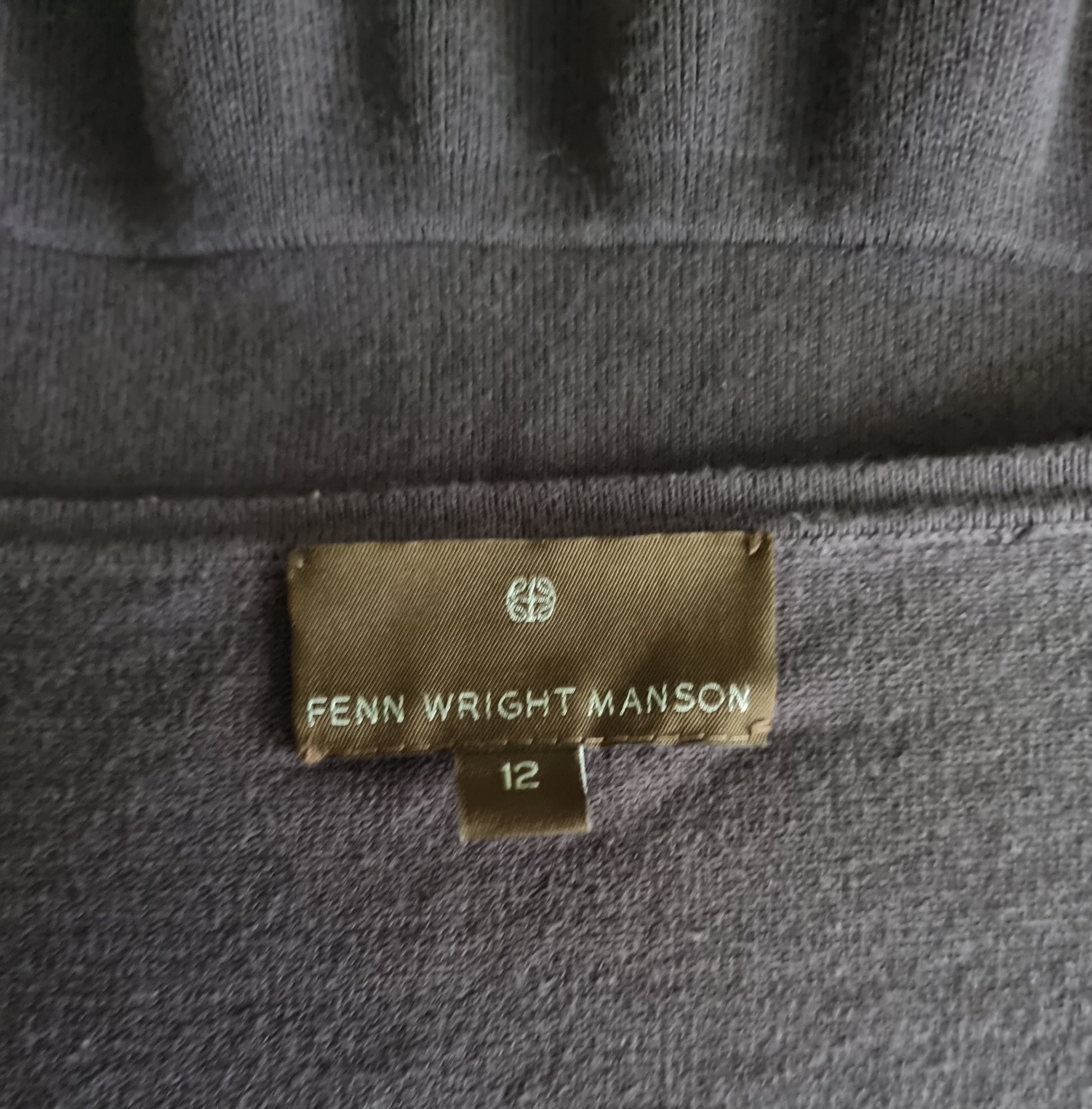 Label on a taupe fabric with 'Fenn Wright Manson' branding
