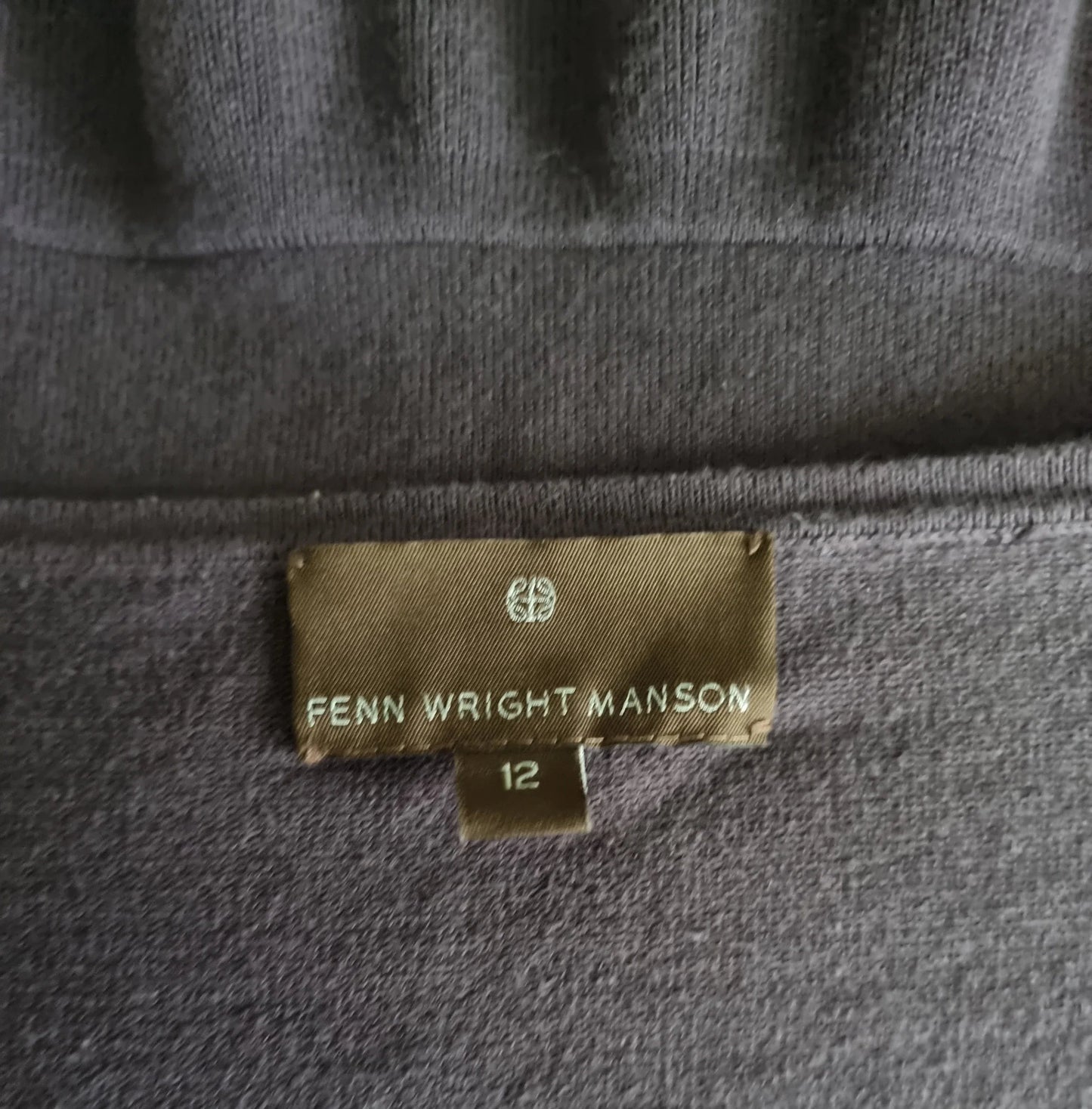 Garment label with Fenn Wright Manson on brown background