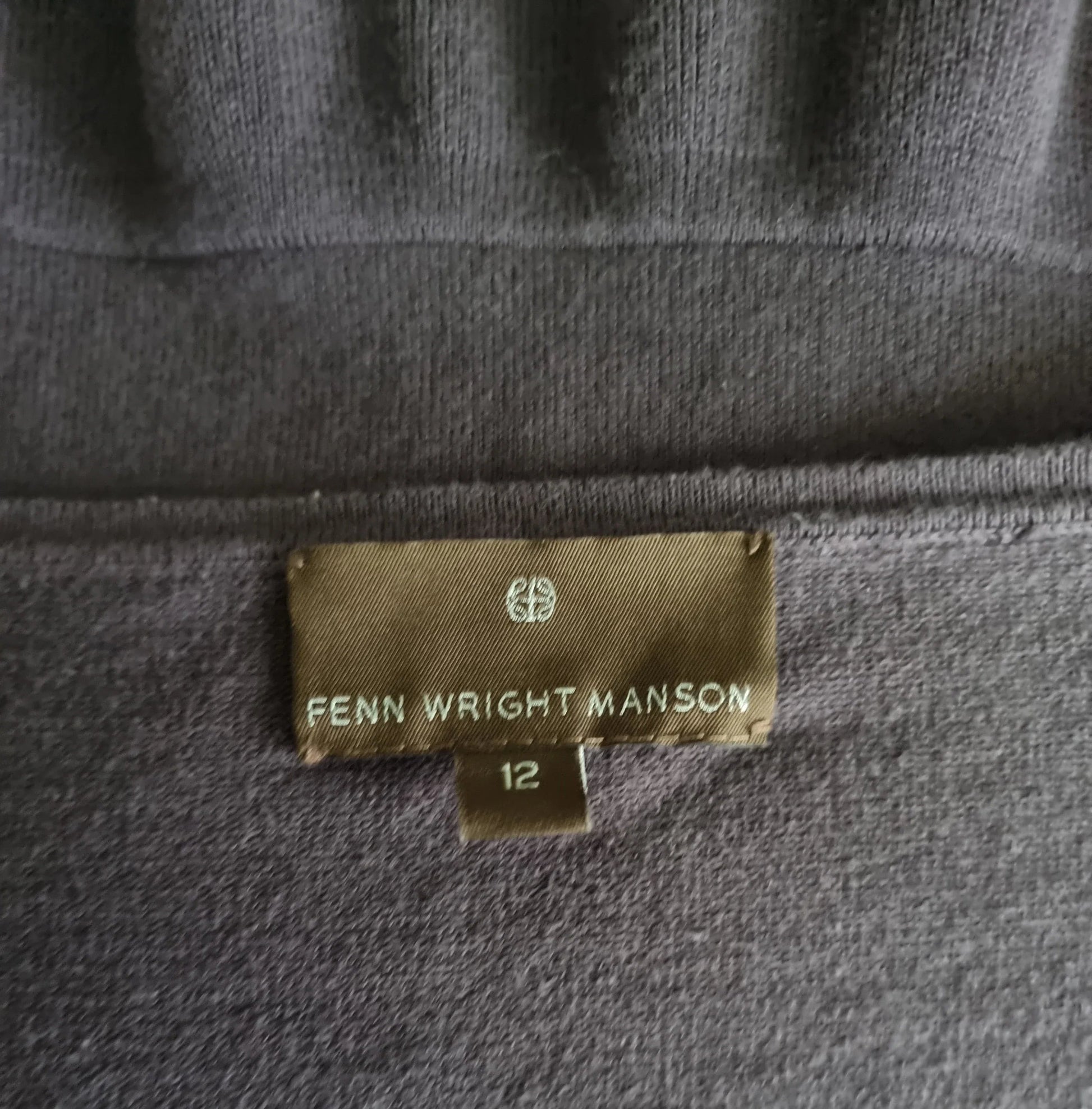Garment label with Fenn Wright Manson on brown background