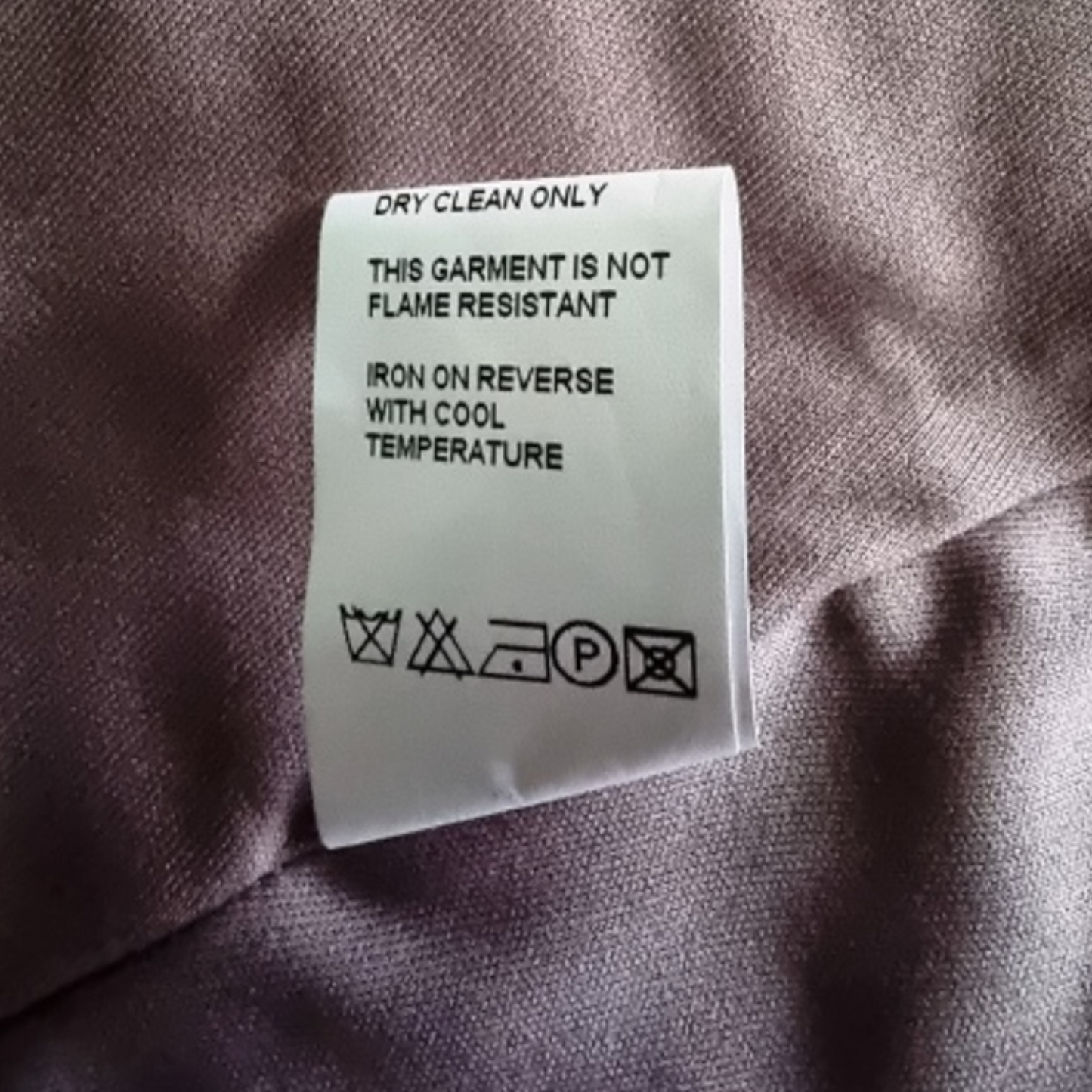 Clothing label on a garment with care instructions.
