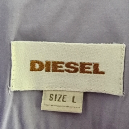 Garment label with 'Diesel' and size details on lilac background
