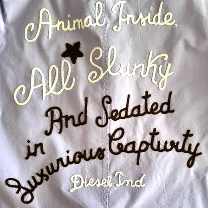 Embroidered detail on back of men's lilac shirt