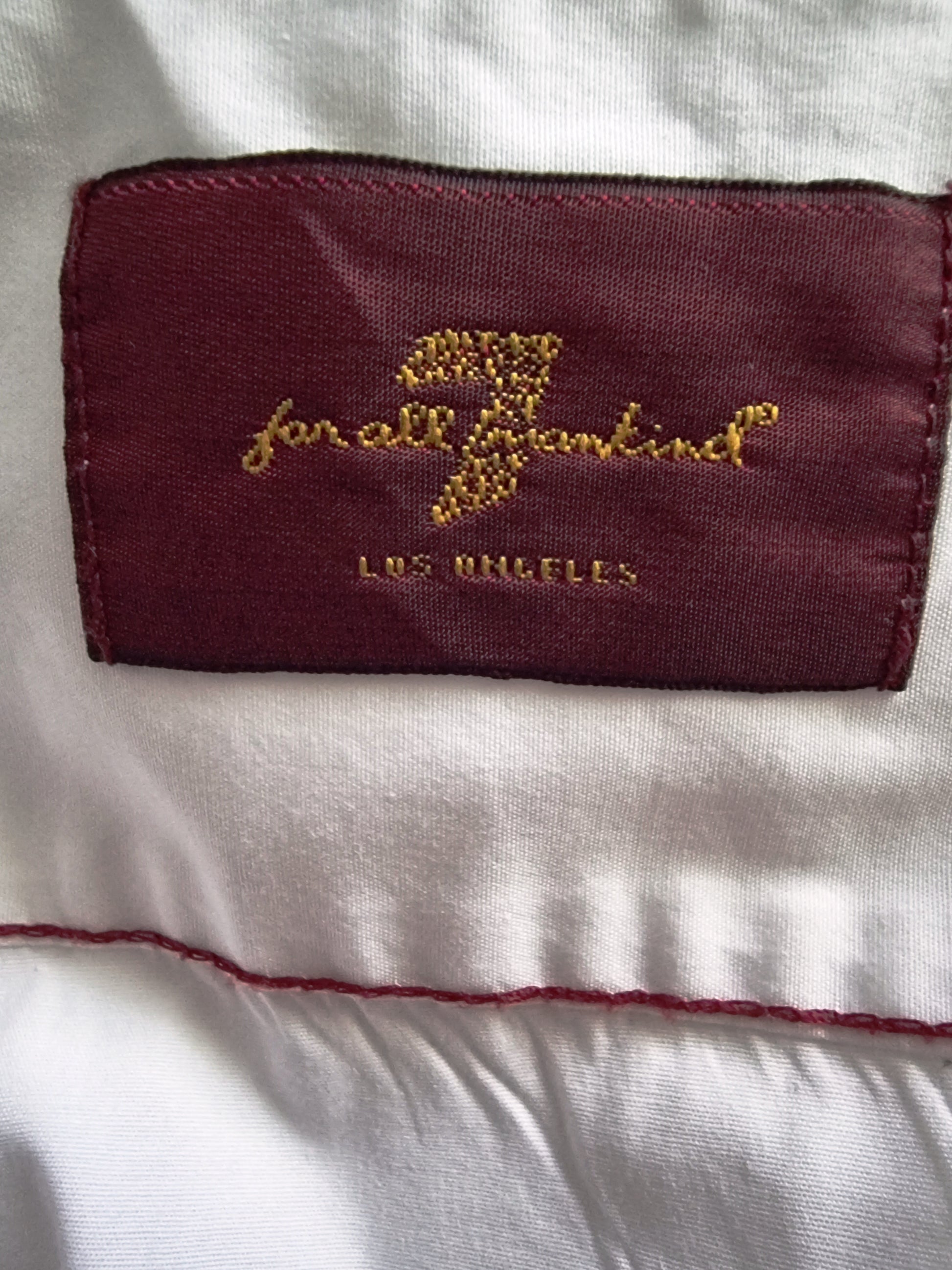 Embroidered label on a white garment with 'Los Angeles' text