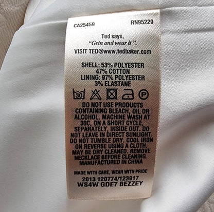 Clothing label with text and symbols on a white fabric background