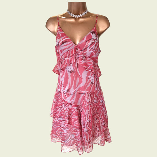 Mannequin wearing a pink summer mini dress on beige background