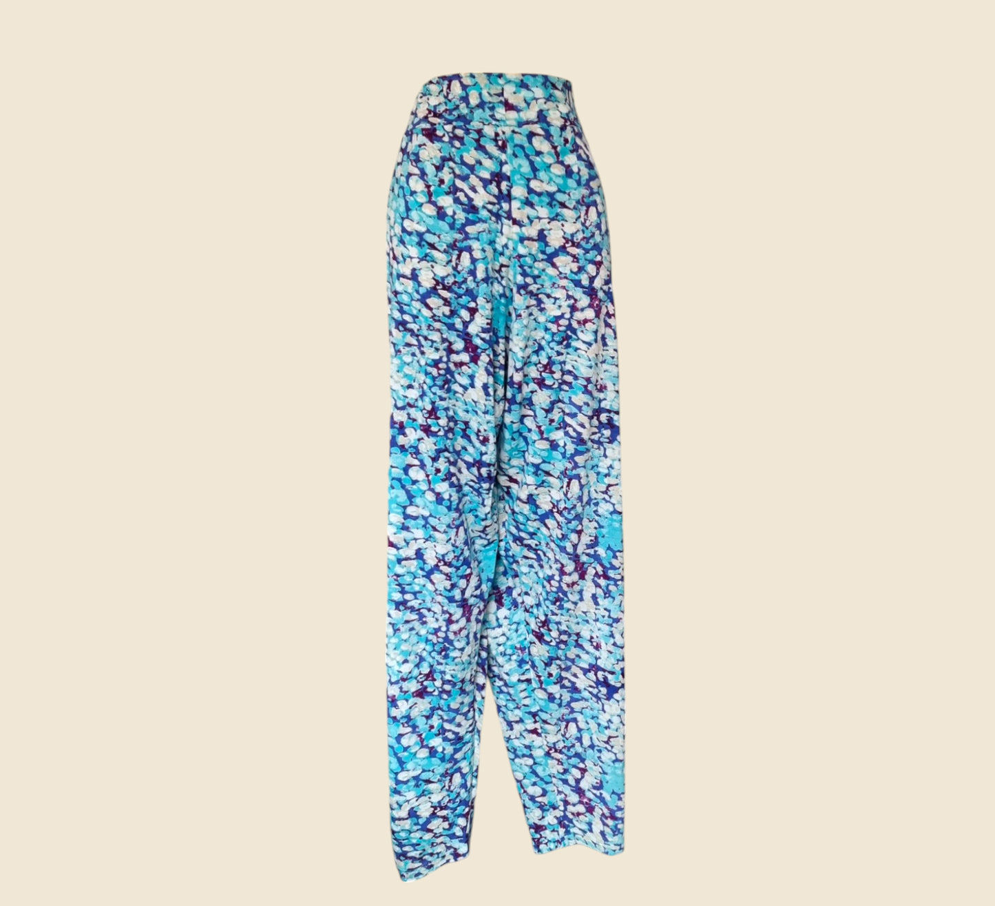 Blue and purple patterned pants on a beige background