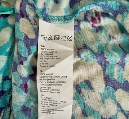 Fabric with a floral pattern and a label with washing instructions.