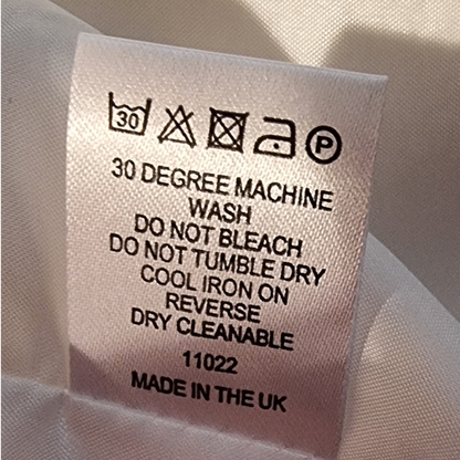Washing instructions label on a fabric background