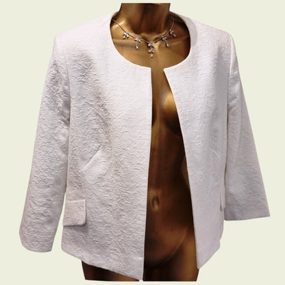 White blazer on a mannequin against a light background