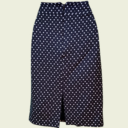 Black skirt with white polka dot pattern on a beige background