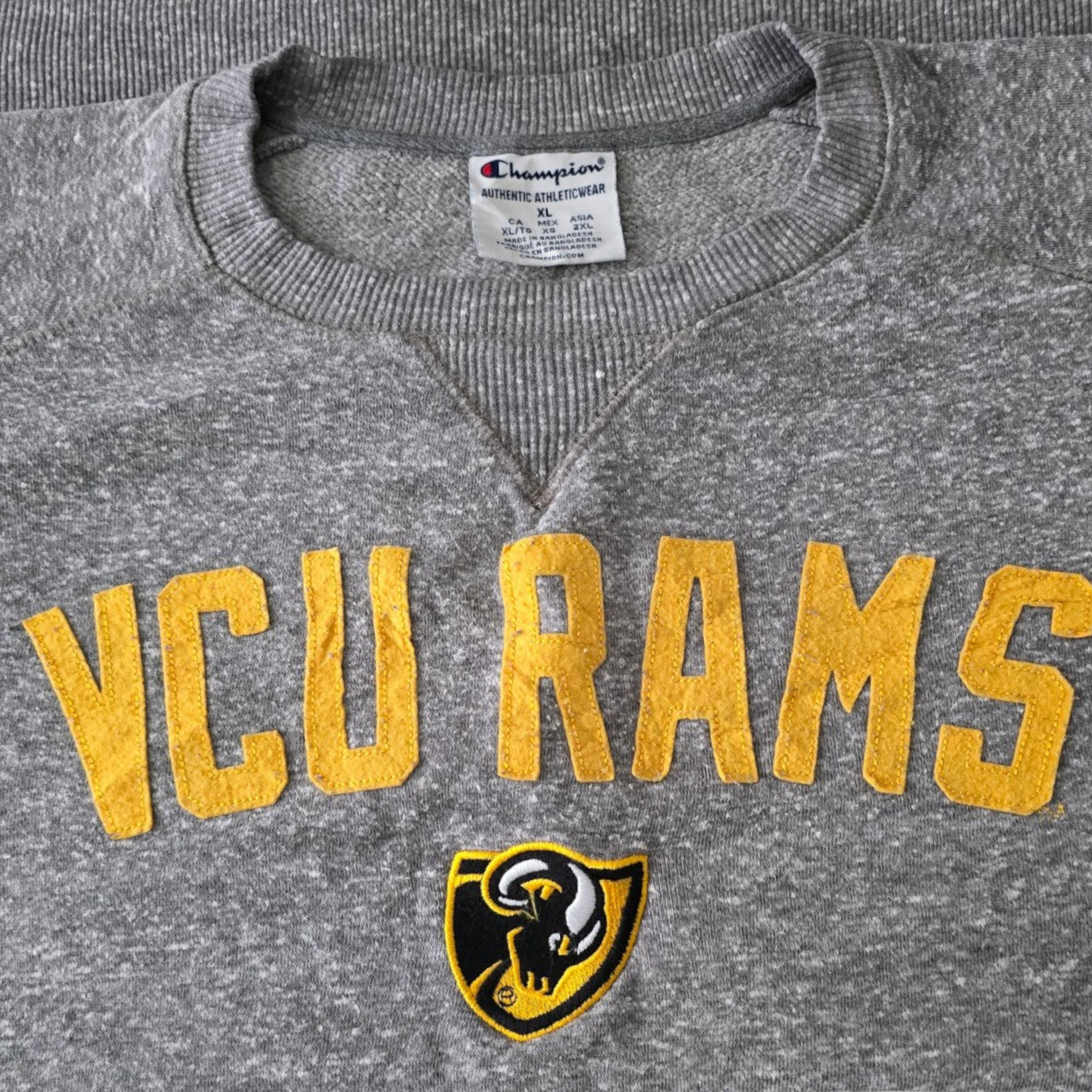 Gray sweatshirt with 'VCU Rams' text and logo, featuring Champion brand label.