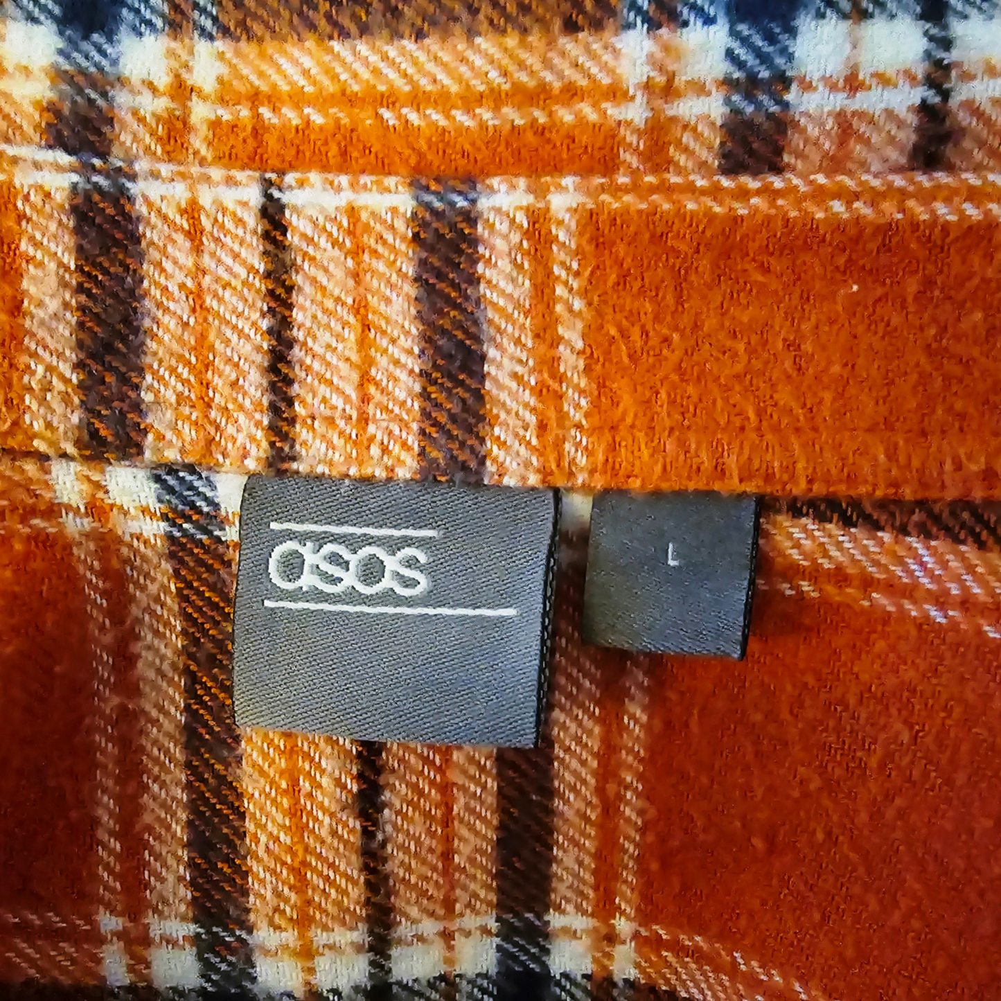 ASOS label on a plaid fabric background