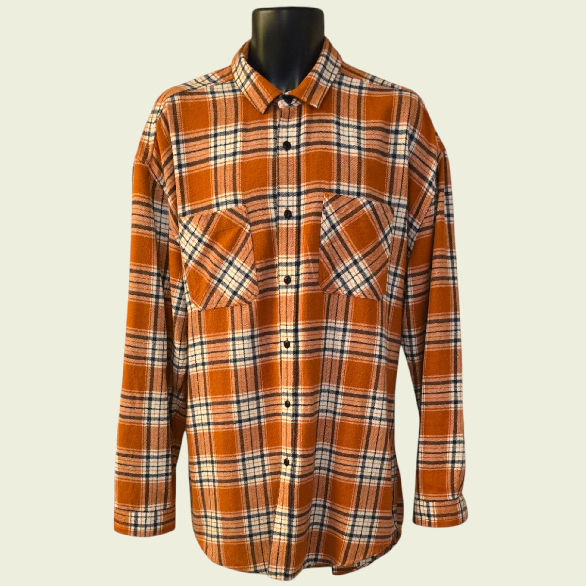 Plaid shirt on a mannequin against a beige background
